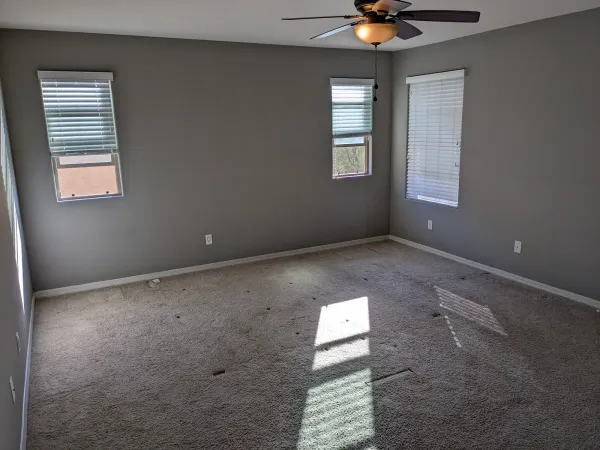 Master bedroom wall before wallpaper accent installation in Mesa