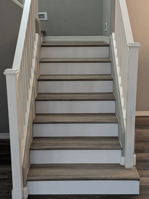 LVP stair installation detail with white risers in Mesa