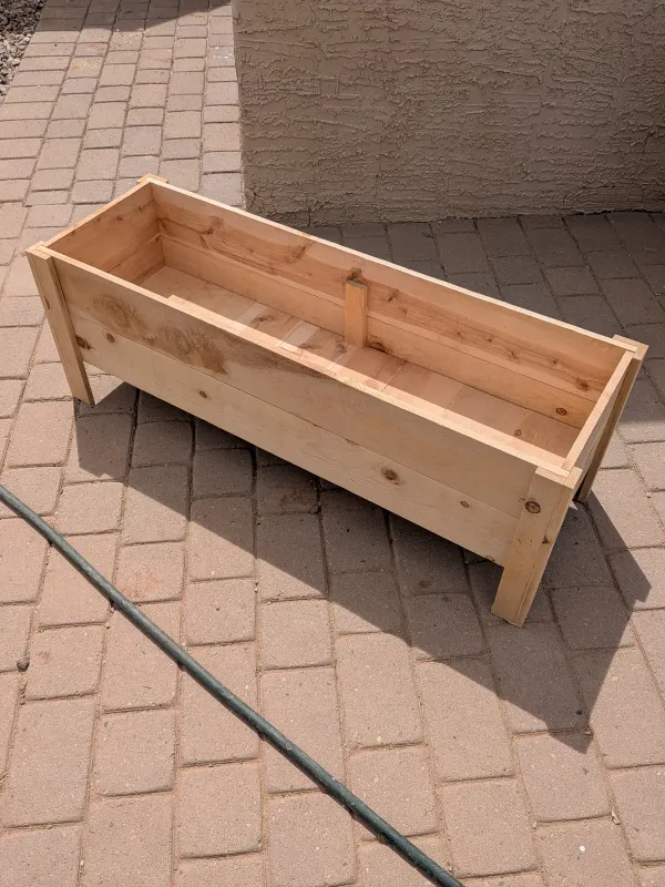 Empty movable cedar planter bed before planting in Gilbert