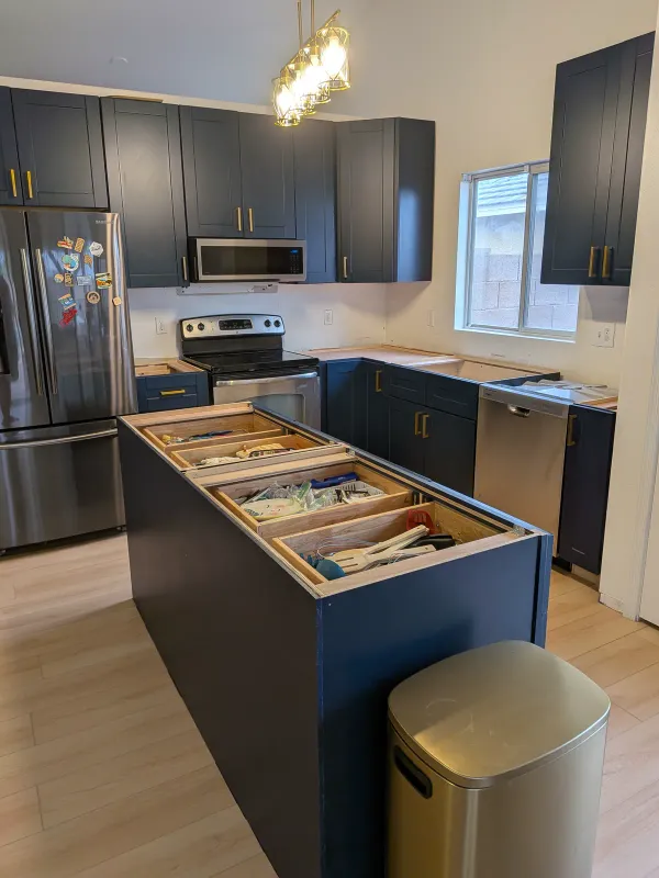 Kitchen cabinet installation progress with upper cabinets in Gilbert