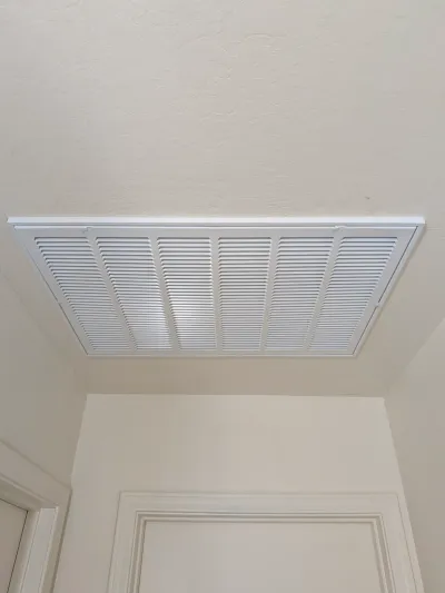 Clean white AC return grille installed in a Gilbert home