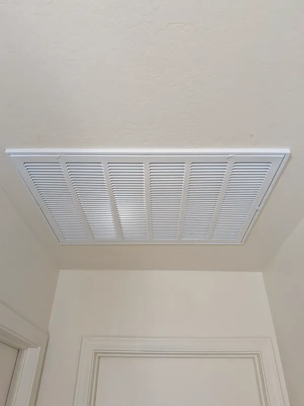 New white AC return grille installed after replacement in Gilbert