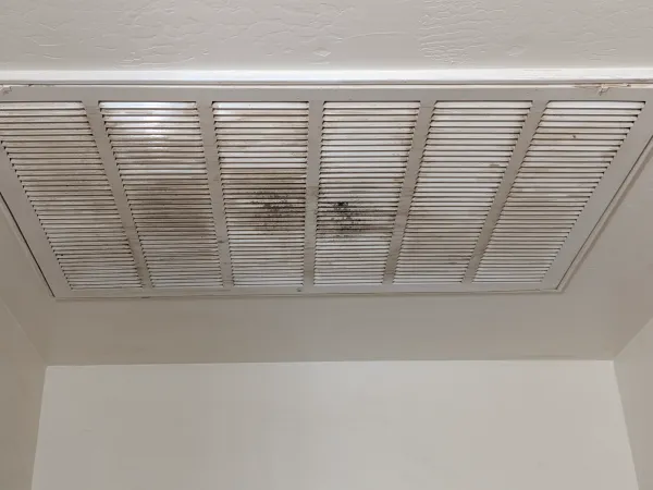 Worn AC return grille detail before replacement in Gilbert