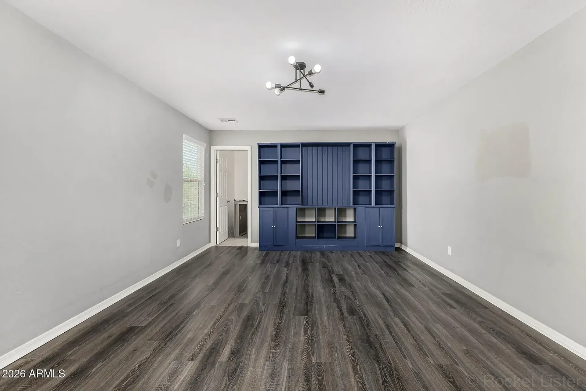 Finished custom bookshelf built-in with lower cabinet storage in Mesa